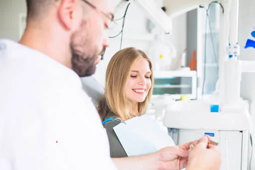 Dentist explaining dental crown options to patient