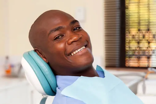 Happy man smiling in dental chair during family dentistry visit